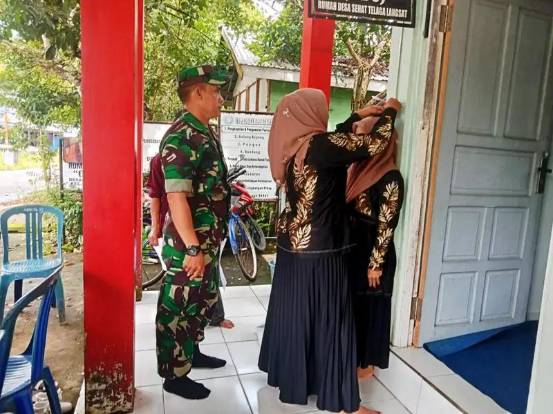Bersama Puskesmas Telaga Langsat Babinsa Laksanakan Pelayanan Kesehatan Posyandu